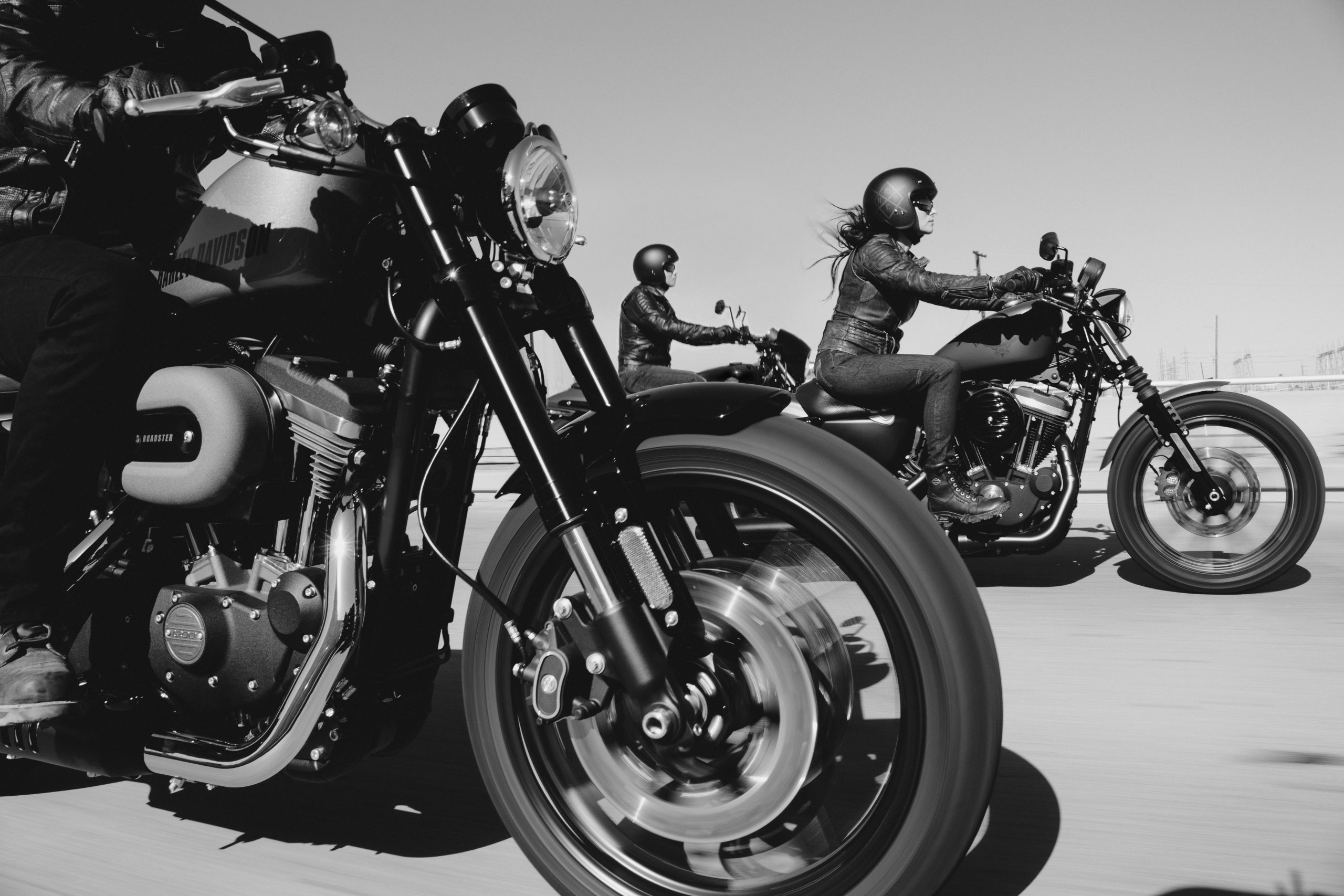 Three people riding motorcycles